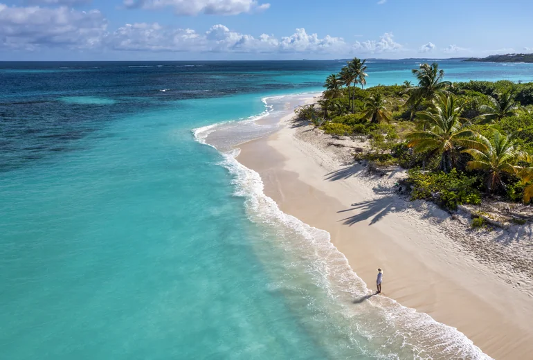 Pristine Caribbean beach with one walker